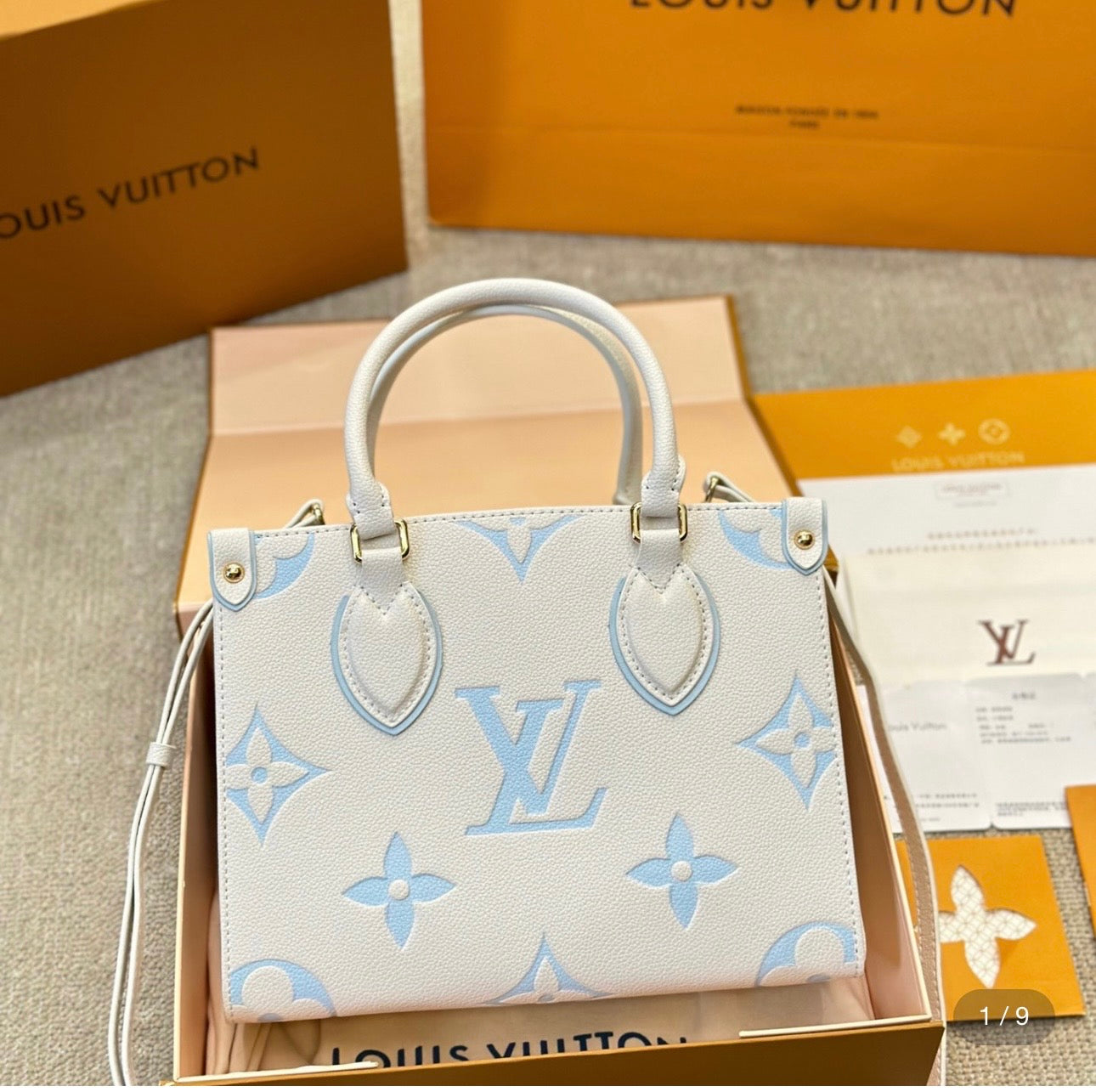Louis Vuitton Empreinte Monogram Giant Onthego PM, Crafted in rich latte with striking candy blue accents