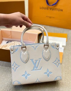 Louis Vuitton Empreinte Monogram Giant Onthego PM, Crafted in rich latte with striking candy blue accents